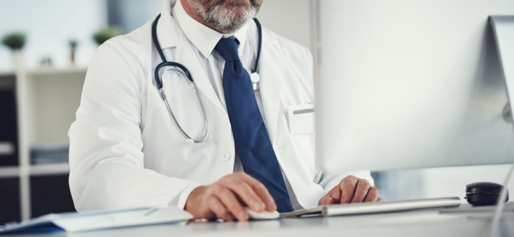 Healthcare provider reviewing remote patient monitoring data and AI clinical decision support tools integrated with SecureVideo telehealth platform during a virtual visit