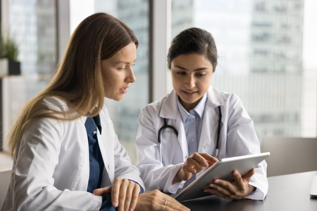 Specialist reviewing patient records during a telehealth second opinion consultation